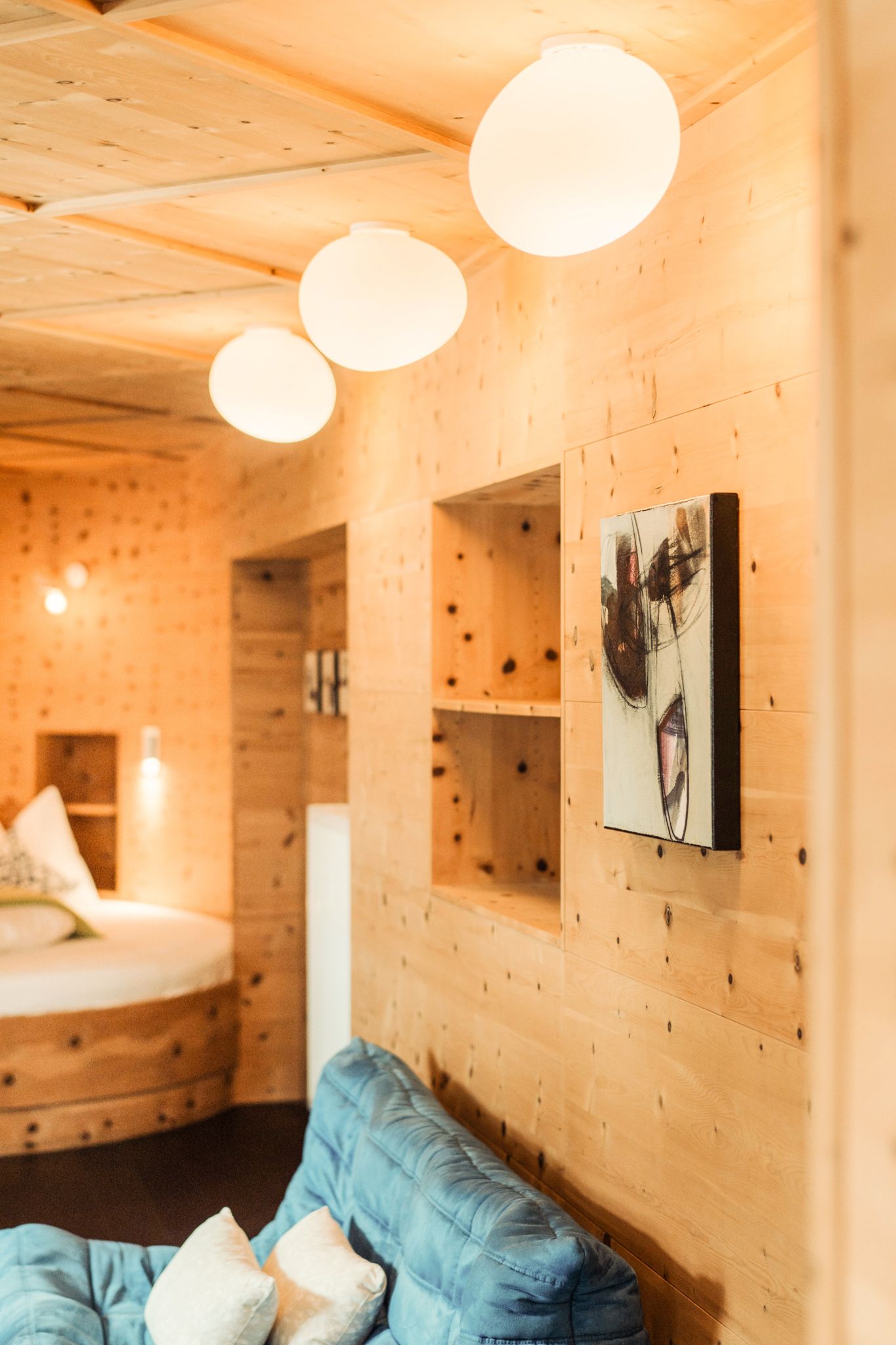 Cozy room in Glemmtalerhof in Hinterglemm with wooden panels and modern lamps.