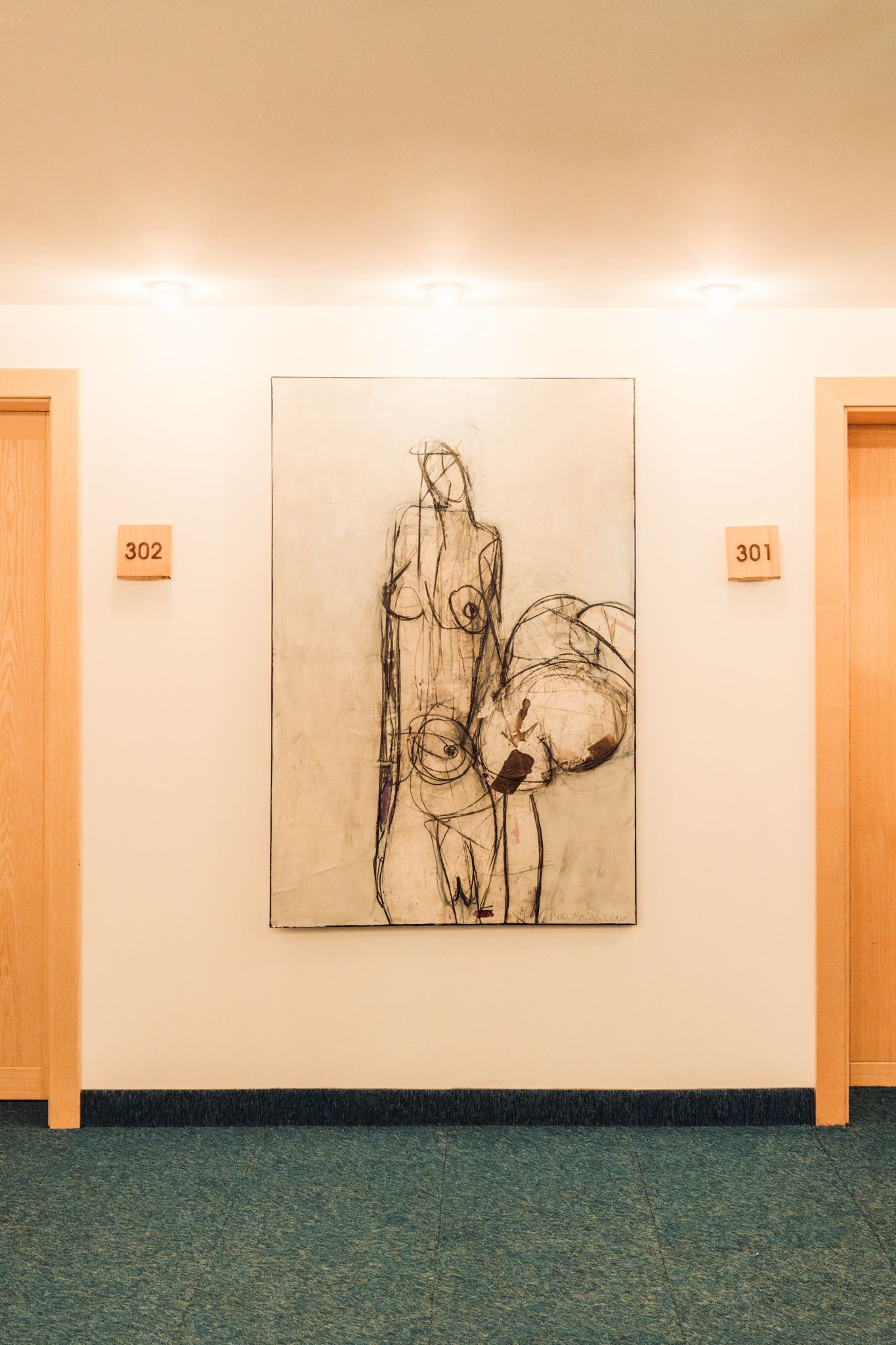 Glemmtalerhof in Hinterglemm with modern rooms and artwork in the hallway.