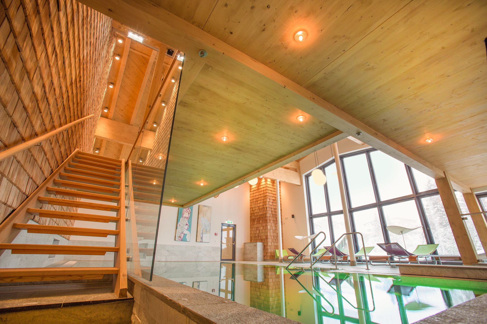 Glemmtalerhof in Hinterglemm features modern stairs and a pool area filled with light and a relaxing atmosphere.
