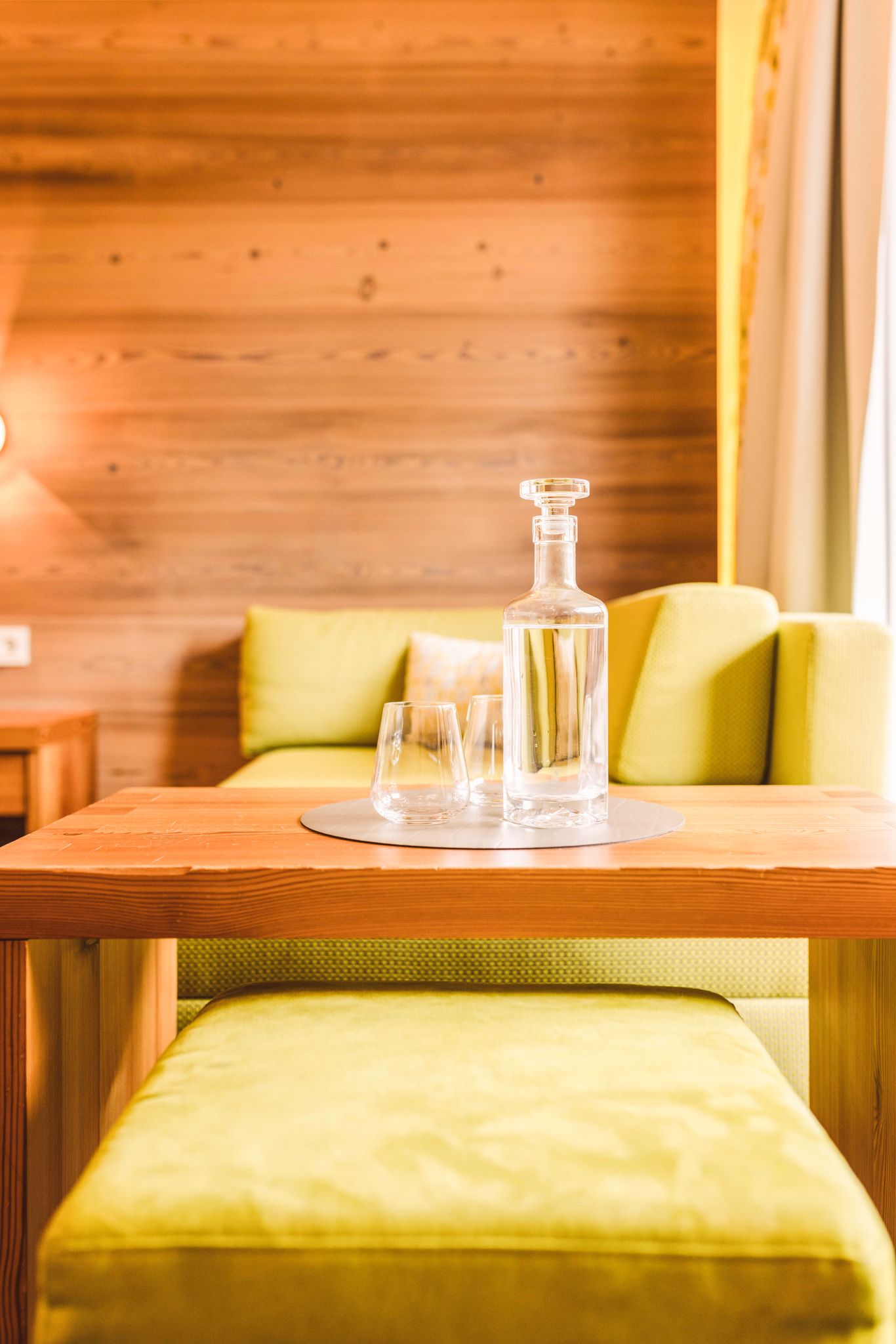 A cozy table with glasses and a carafe in the Glemmtalerhof in Hinterglemm.