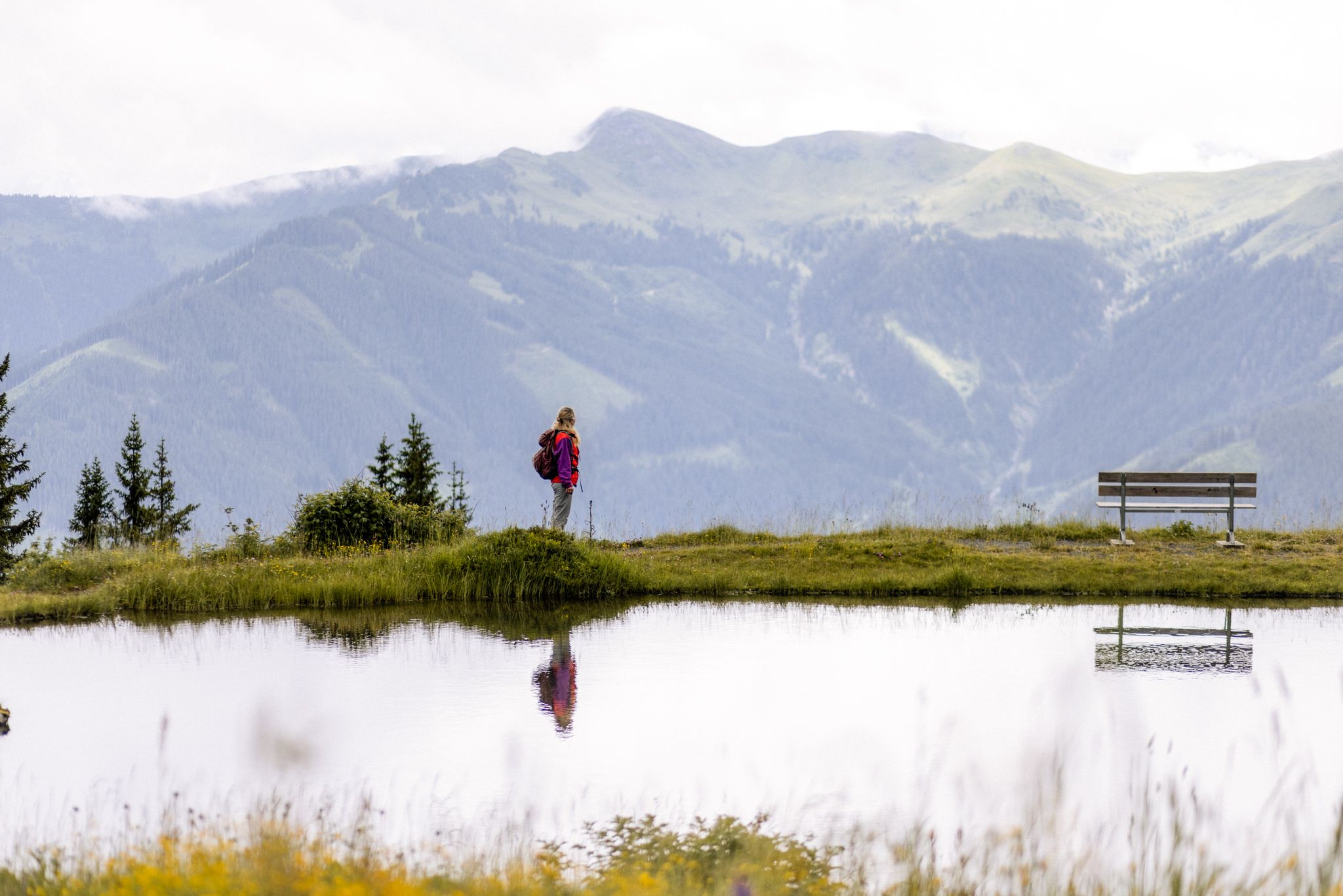A hiker enjoys the view in the Glemmtal near Hinterglemm.