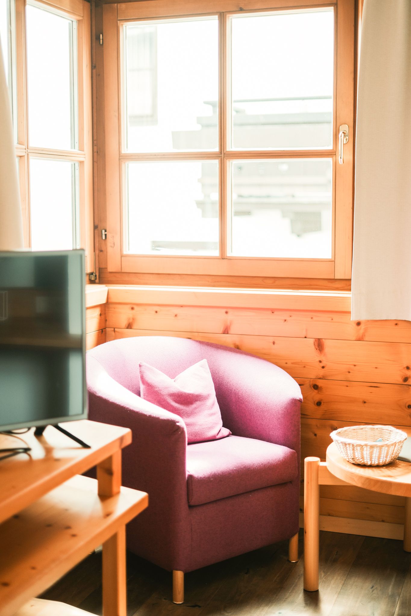 A cozy room in Glemmtalerhof with a purple chair and view of the Glemmtal.