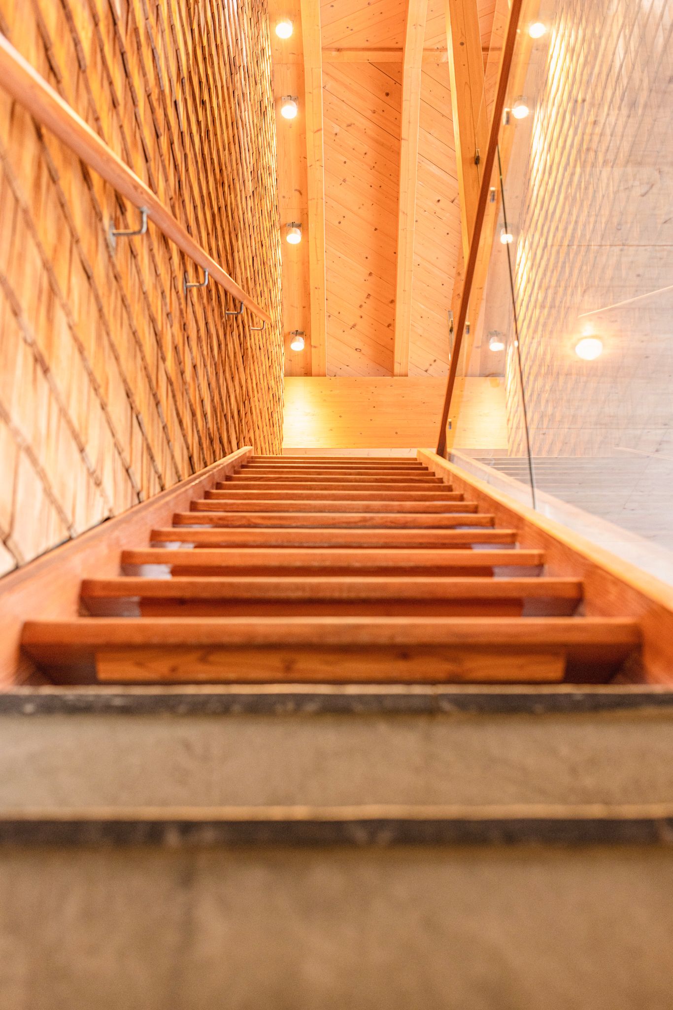 Wooden staircase with warm light in the Glemmtalerhof in Hinterglemm.