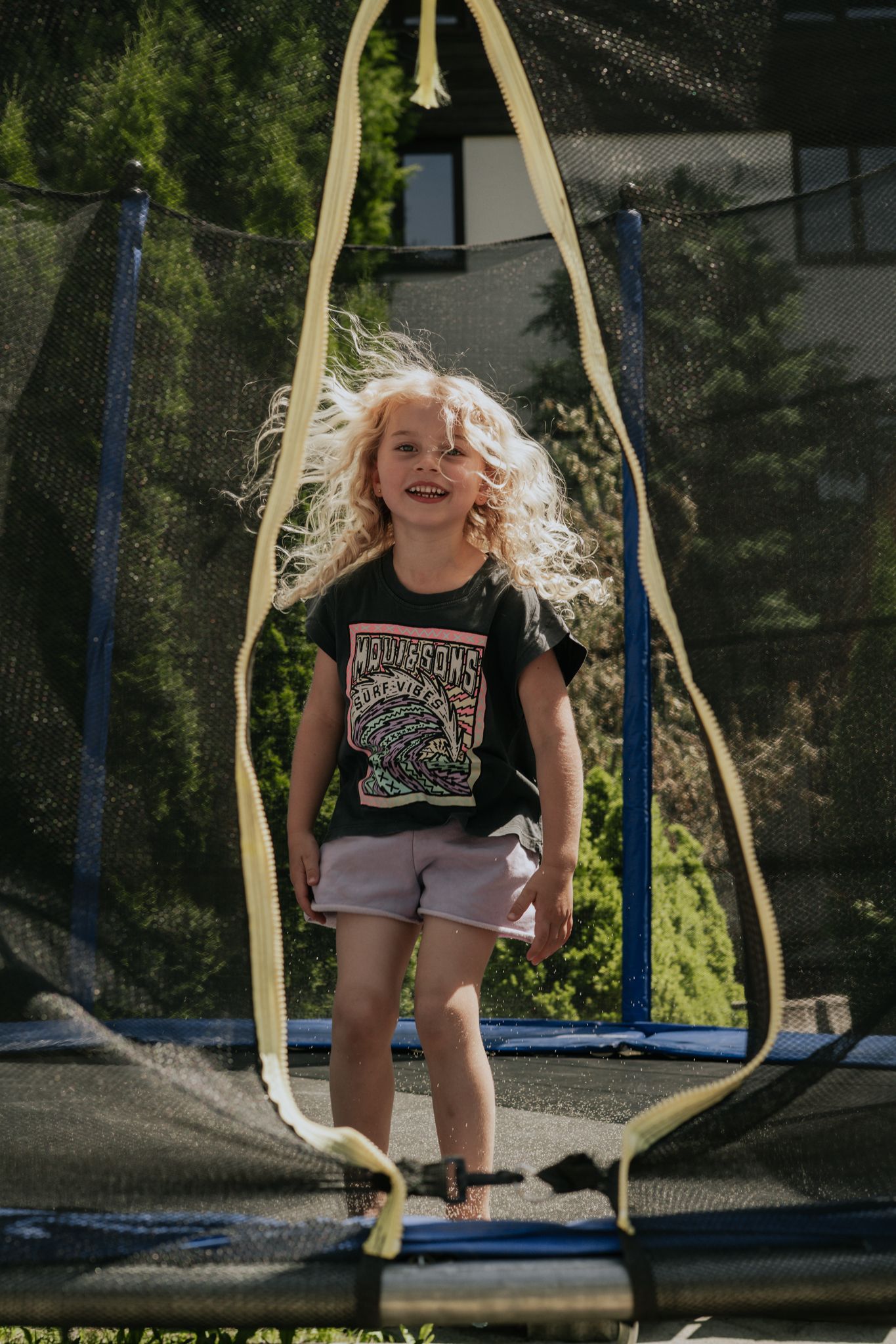 A cheerful child jumps on a trampoline in the Glemmtal.