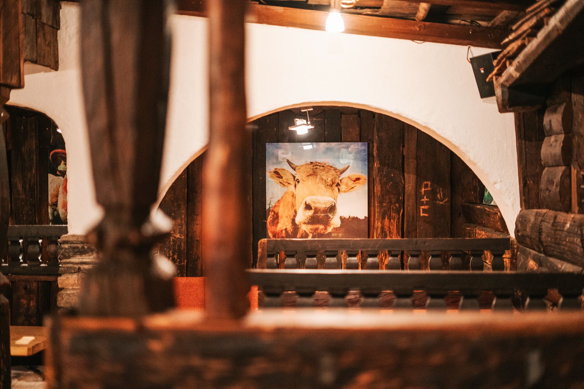 A view inside the Glemmtalerhof featuring a cow painting in rustic decor.