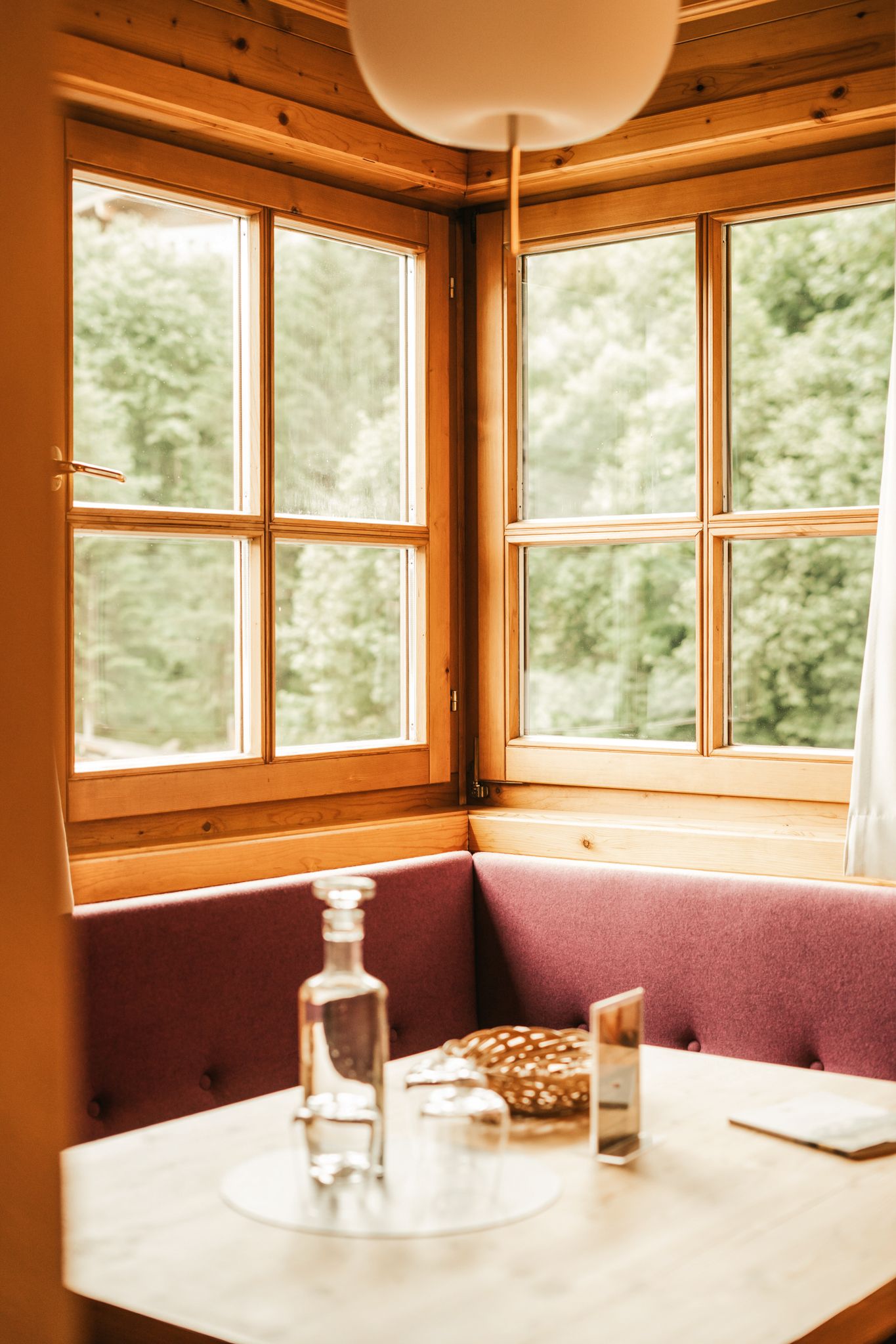 A cozy table in Glemmtalerhof with a view of greenery.