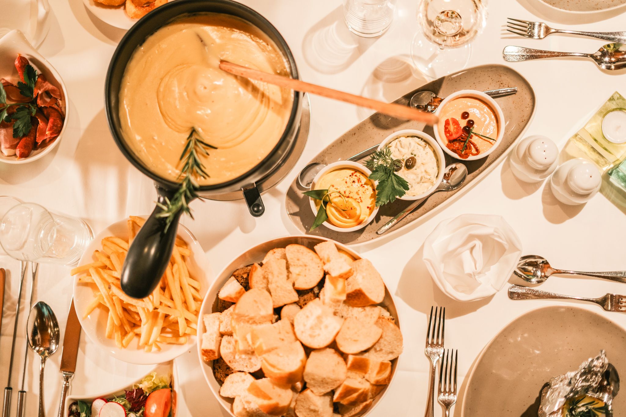 A cozy meal with cheese fondue and sides at Glemmtalerhof in Hinterglemm.