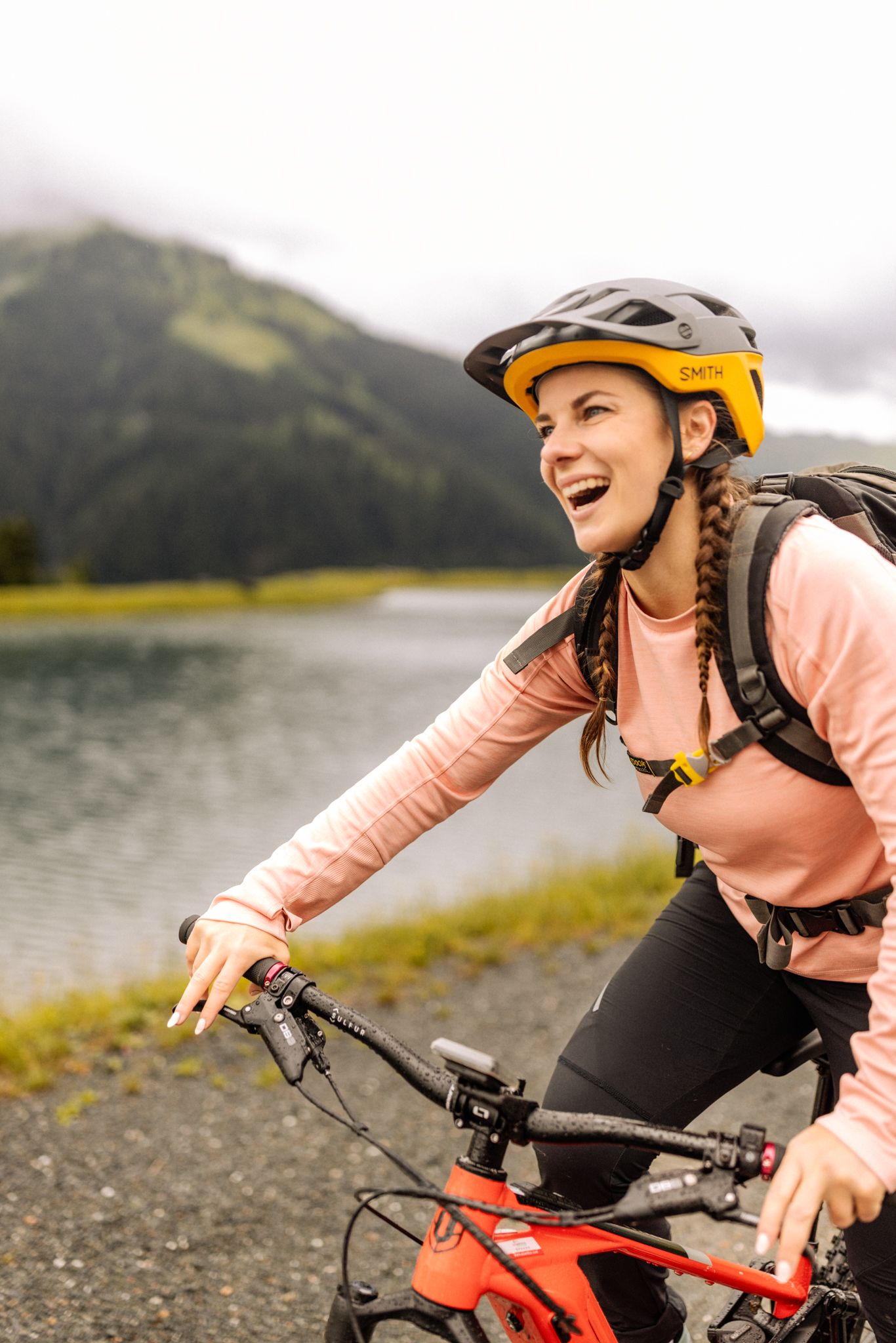 A woman rides a bike near Glemmtalerhof in Hinterglemm. Joy and nature are palpable.