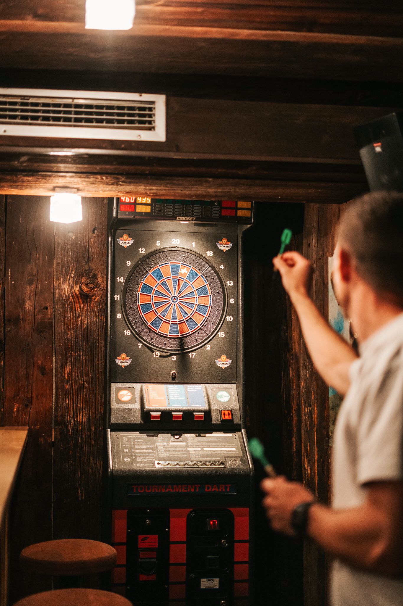 A player throws a dart at an electronic dartboard in Glemmtalerhof in Hinterglemm.