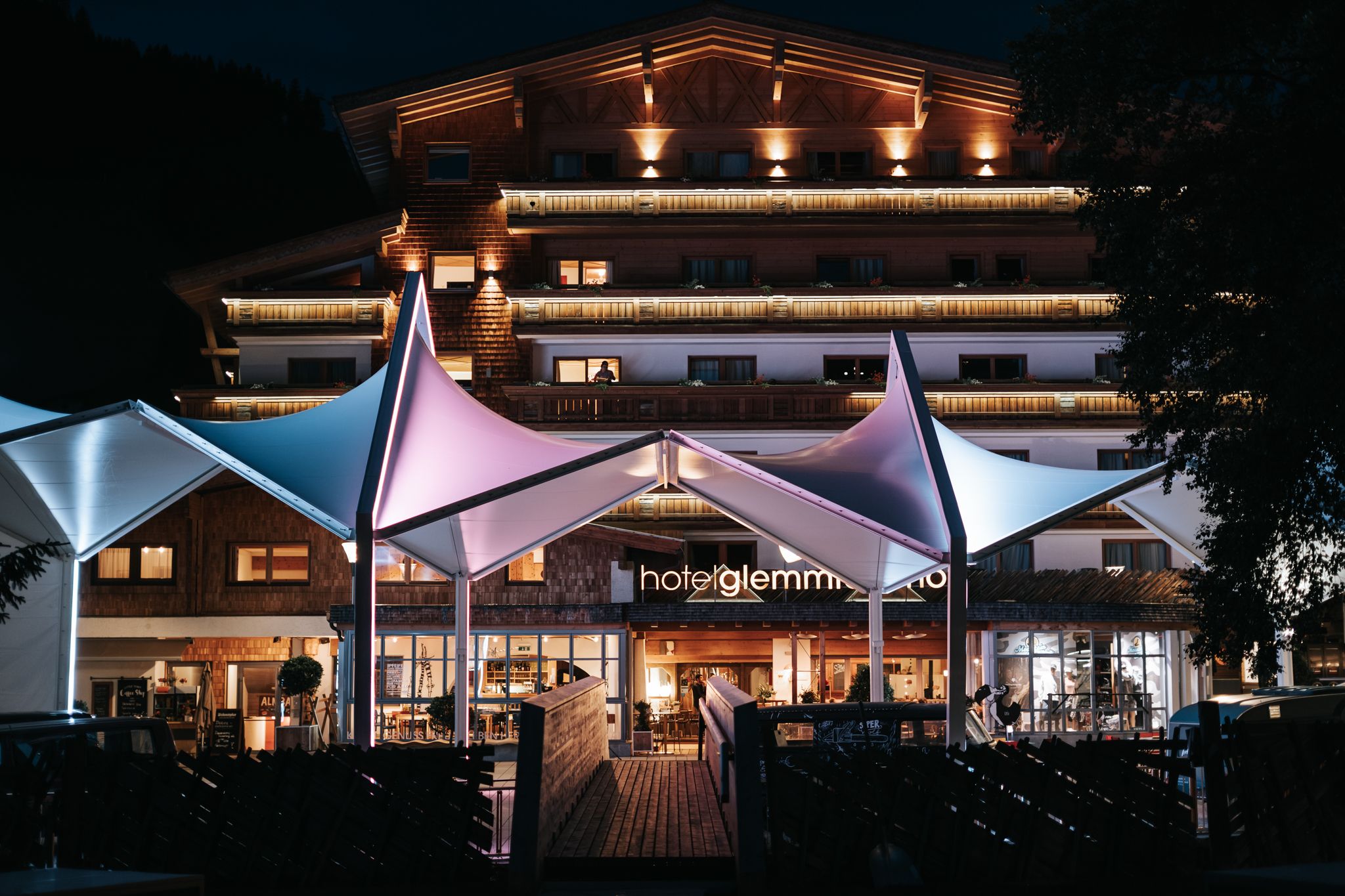 Glemmtalerhof in Hinterglemm shines at night with colorful lights.