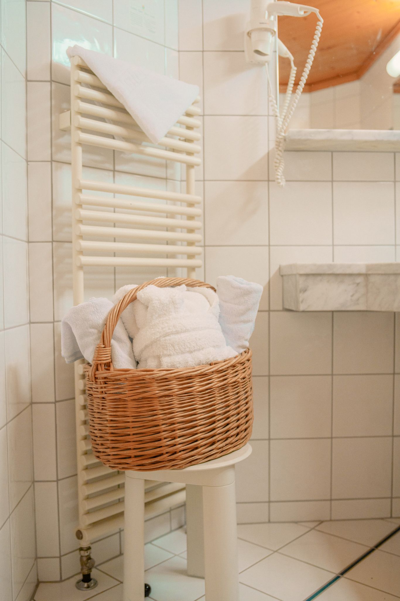 Glemmtalerhof in Hinterglemm with fresh towels in a basket and a modern bathroom setting.