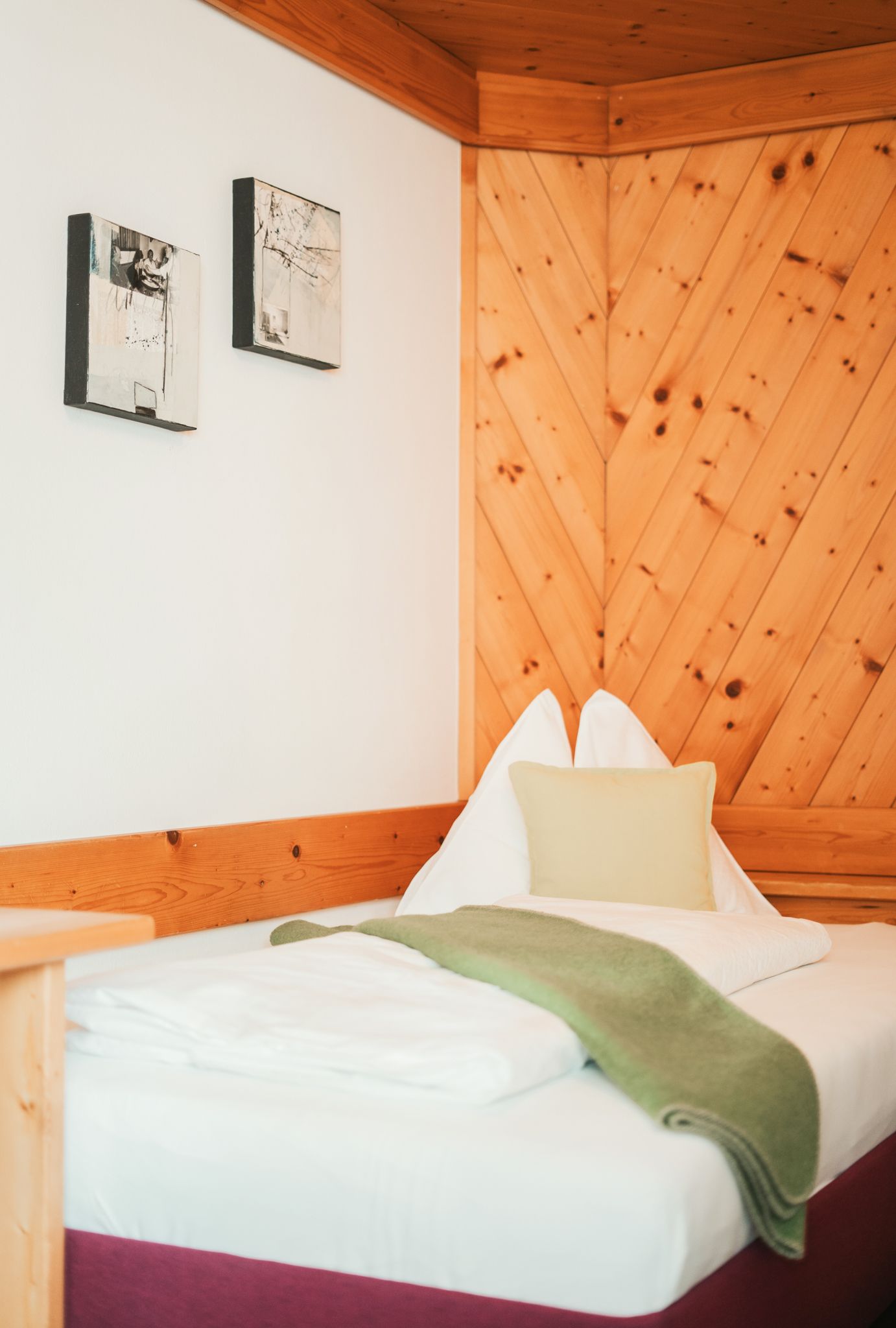 Bright room in Glemmtalerhof in Hinterglemm with wooden paneling and comfortable bed.